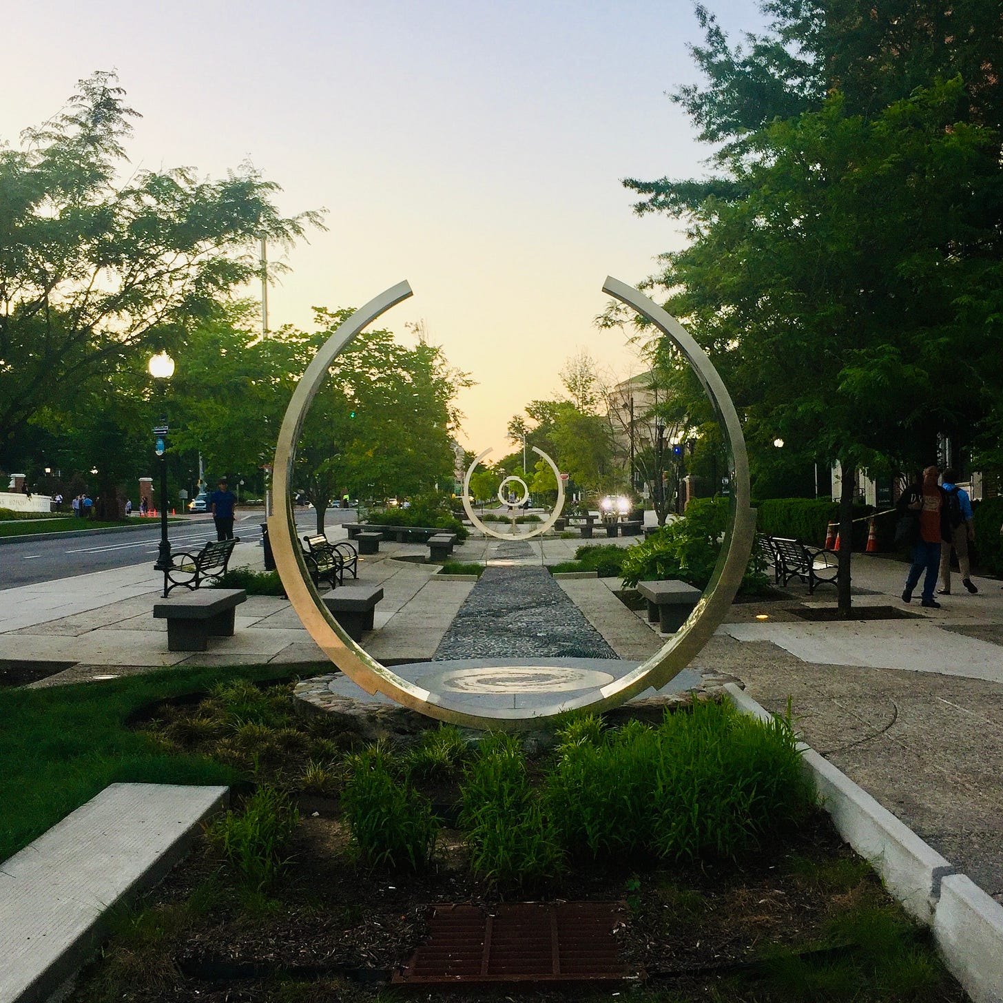 An outdoor art installation featuring three metal circles