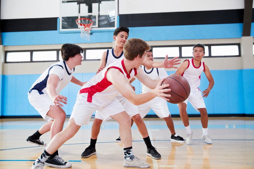 High School Basketball team dribbling