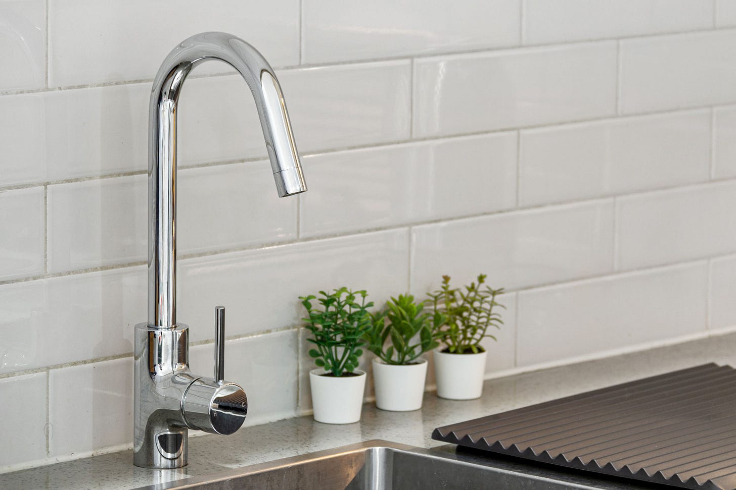 Rubinetto moderno in primo piano per l'erogazione di acqua pura e controllata in cucina Rubinetto moderno in primo piano per l'erogazione di acqua pura e controllata in cucina