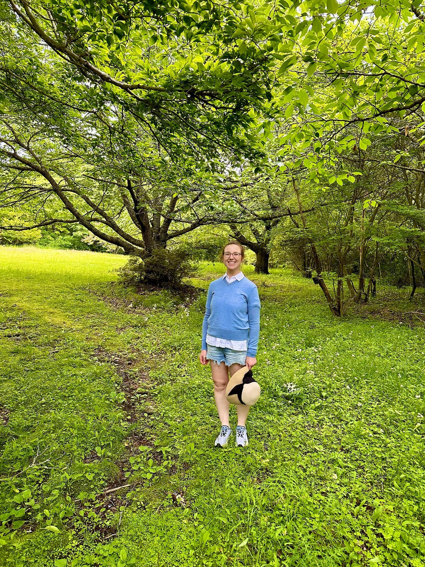 Mari-Alina Timoshchuk at a nature trail in Japan with a blue sweater and shorts