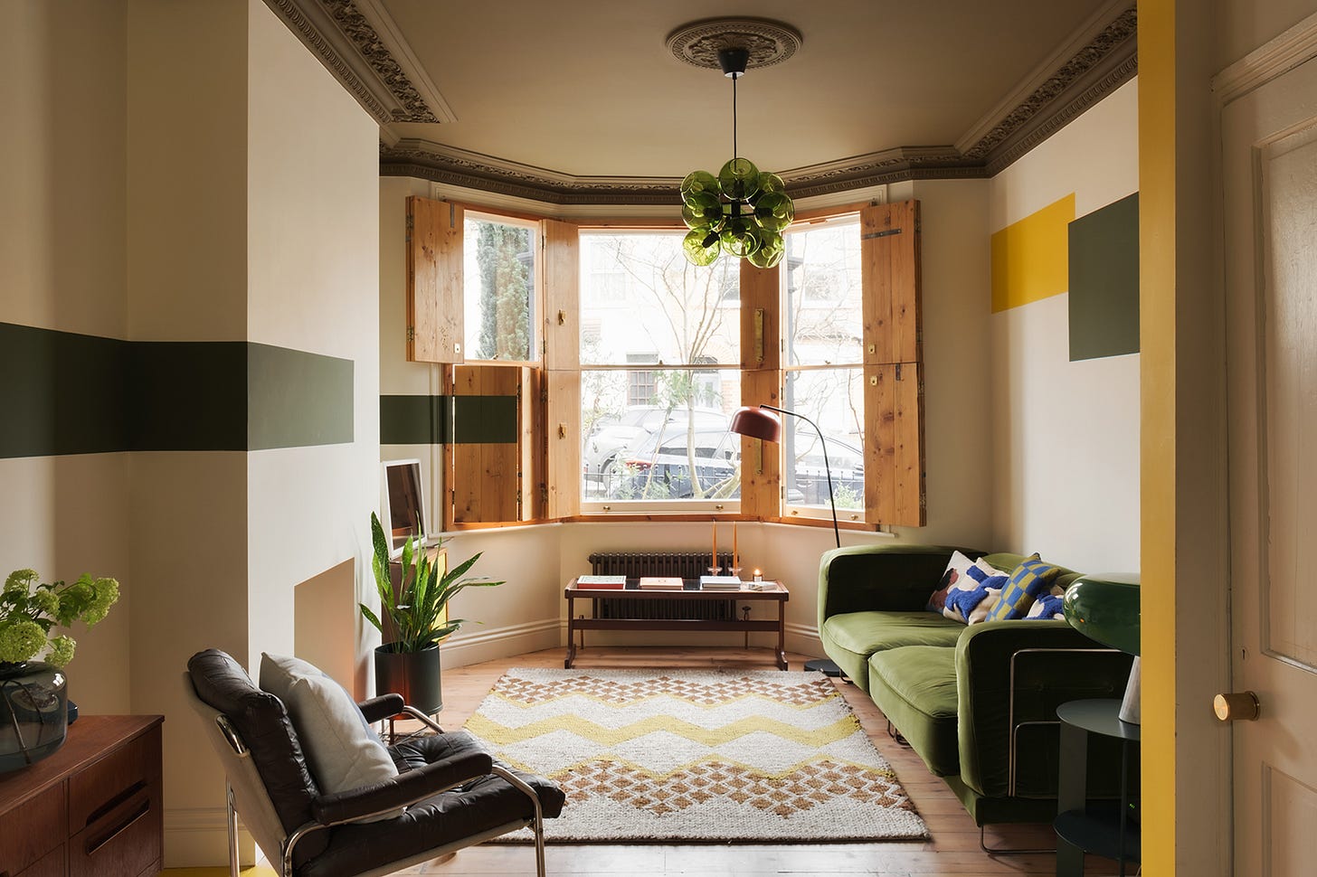 Living room with green furniture and green colorblock walls