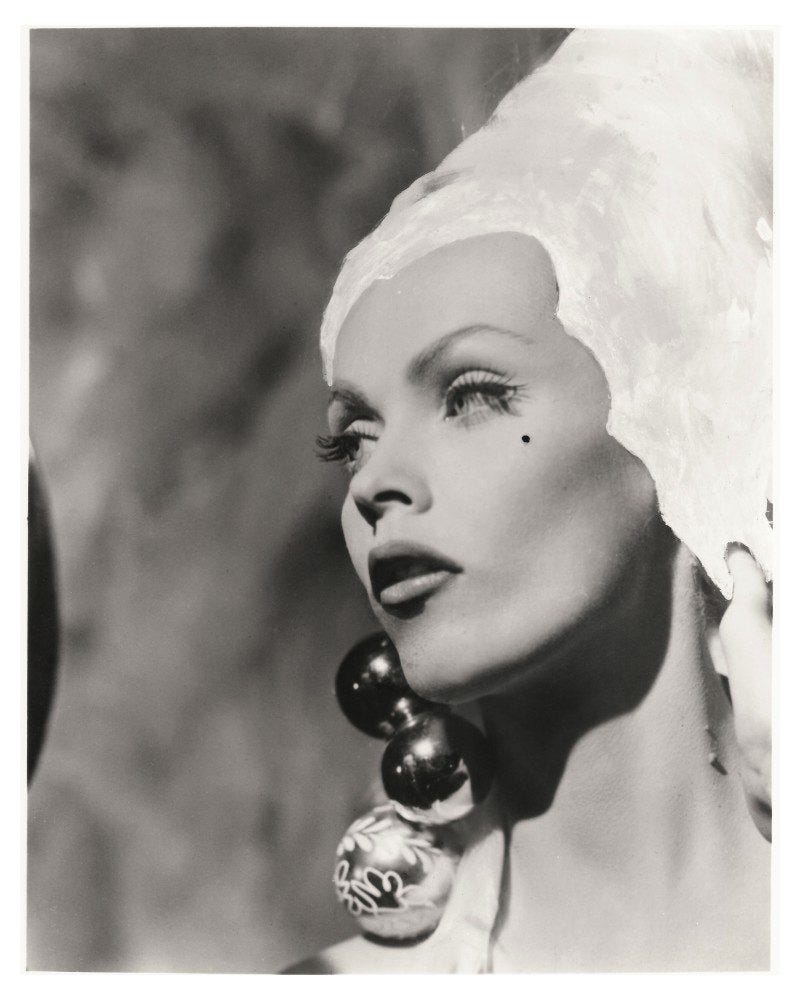 A beautiful woman wearing a white head covering and a long bauble earring A beautiful woman wearing a white head covering and a long bauble earring