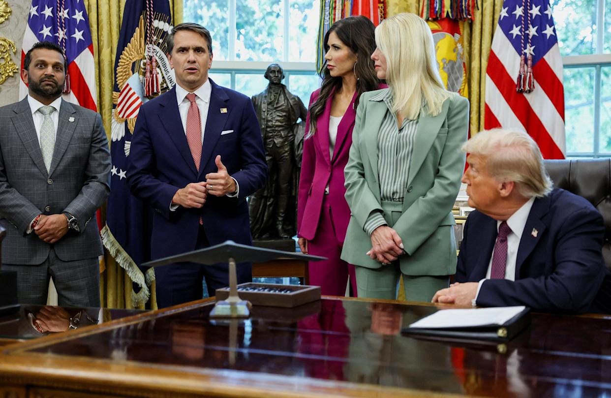 President Donald Trump, U.S. Homeland Security Secretary Kristi Noem, U.S. Attorney General Pam Bondi, and FBI Director Kash Patel listen as Deputy Attorney General Todd Blanche speaks.