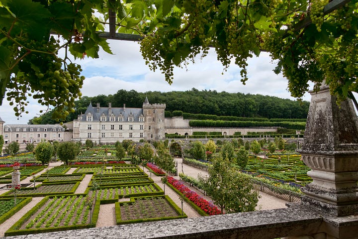 Two images of the Château de Villandry, one with the stone castle and a staircase flanking gardens, the other showing the intricate maze-like gardens all in green