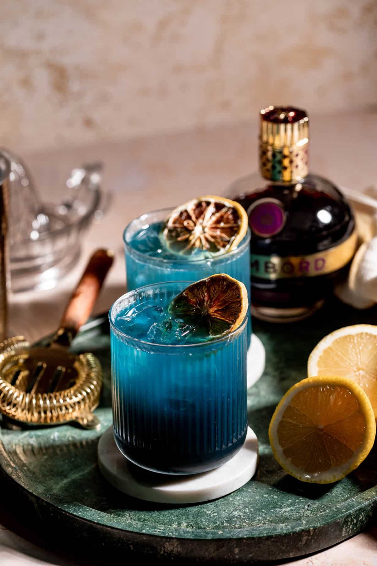 black opal drink on green marble and chambord bottle in background