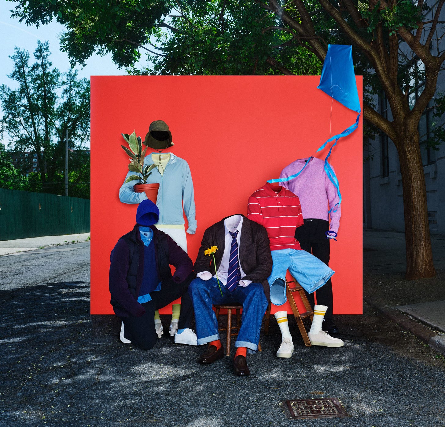 Invisible figures wearing clothing posed in front of a red background. Invisible figures wearing clothing posed in front of a red background.