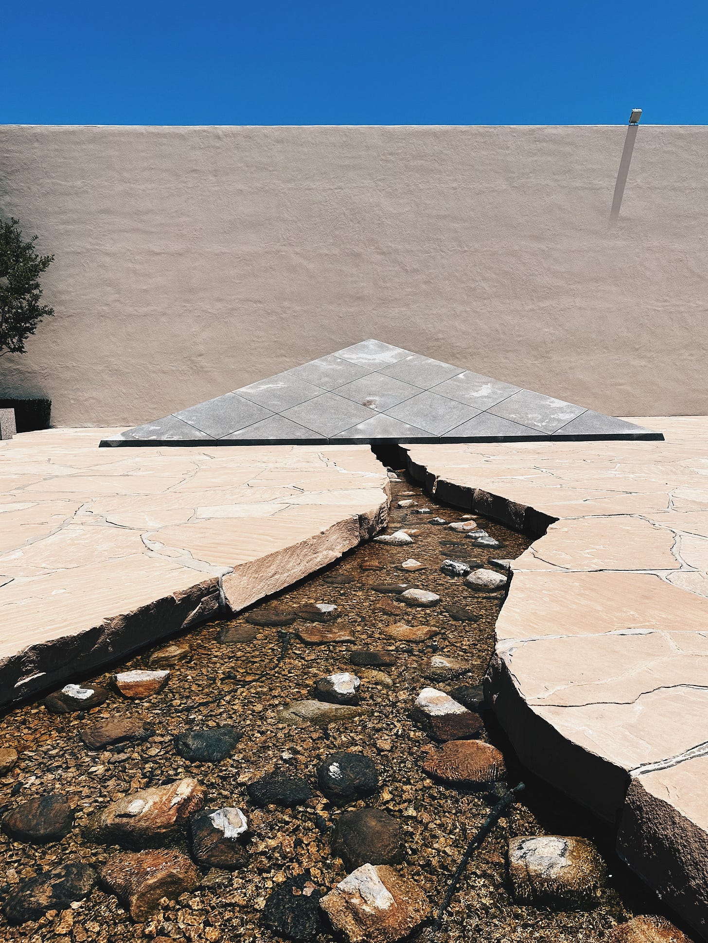 Isamu Noguchi's California Scenario sculpture garden with water channel and sandstone at South Coast Plaza