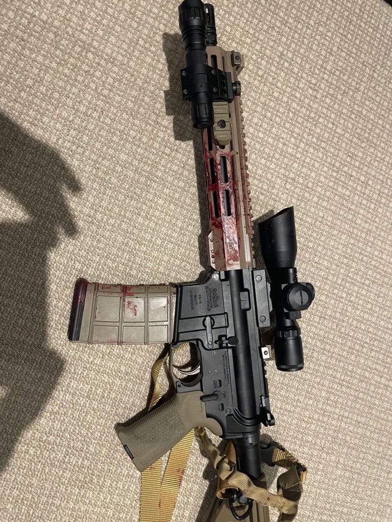 Blood-stained AR-15 rifle. Blood-stained AR-15 rifle.