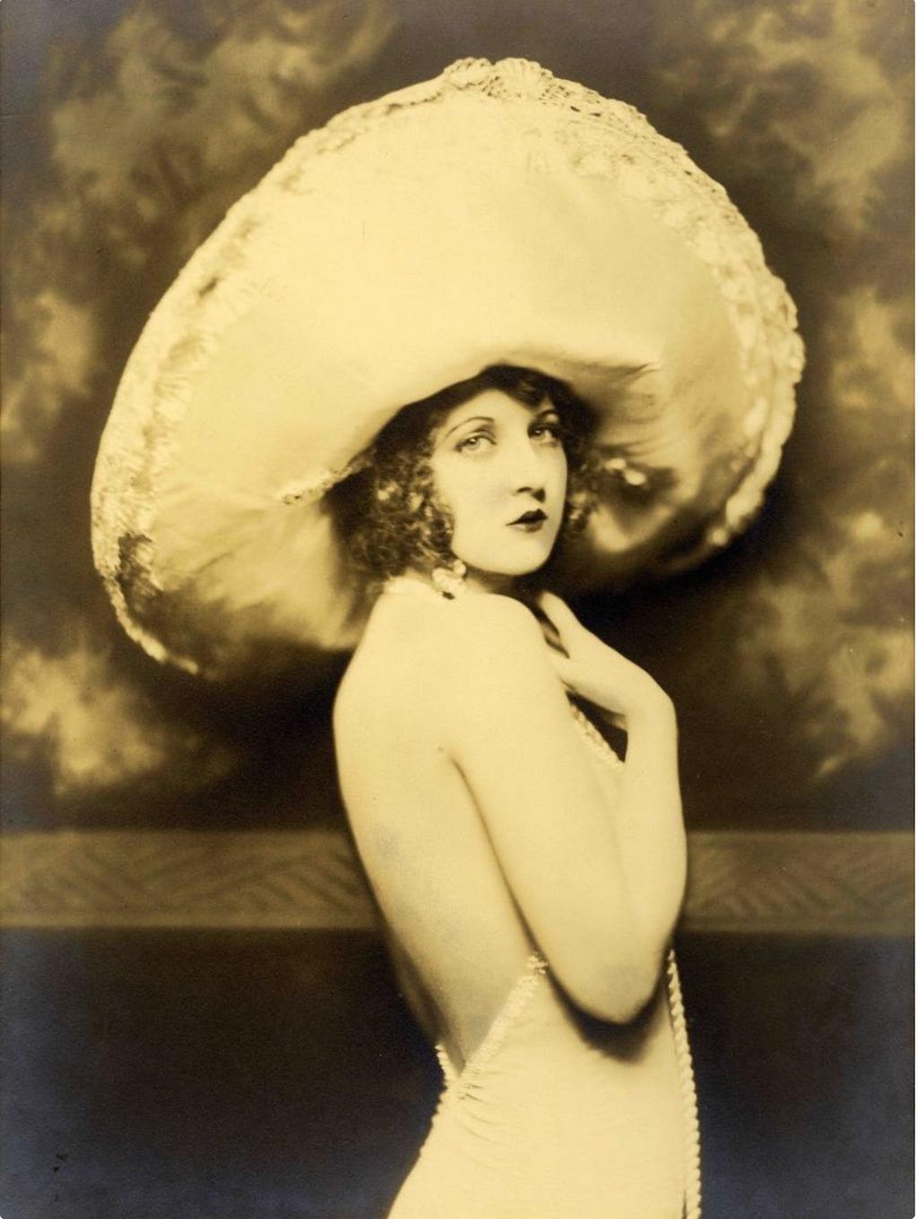 Portrait of Katherine Burke (circa 1923) by Alfred Cheney Johnston. A visual cue for creatives working on period films, historical novels, or biopics. Ideal reference for actors preparing for 1920s roles, screenwriters seeking era-specific authenticity, and filmmakers researching costume drama aesthetics.