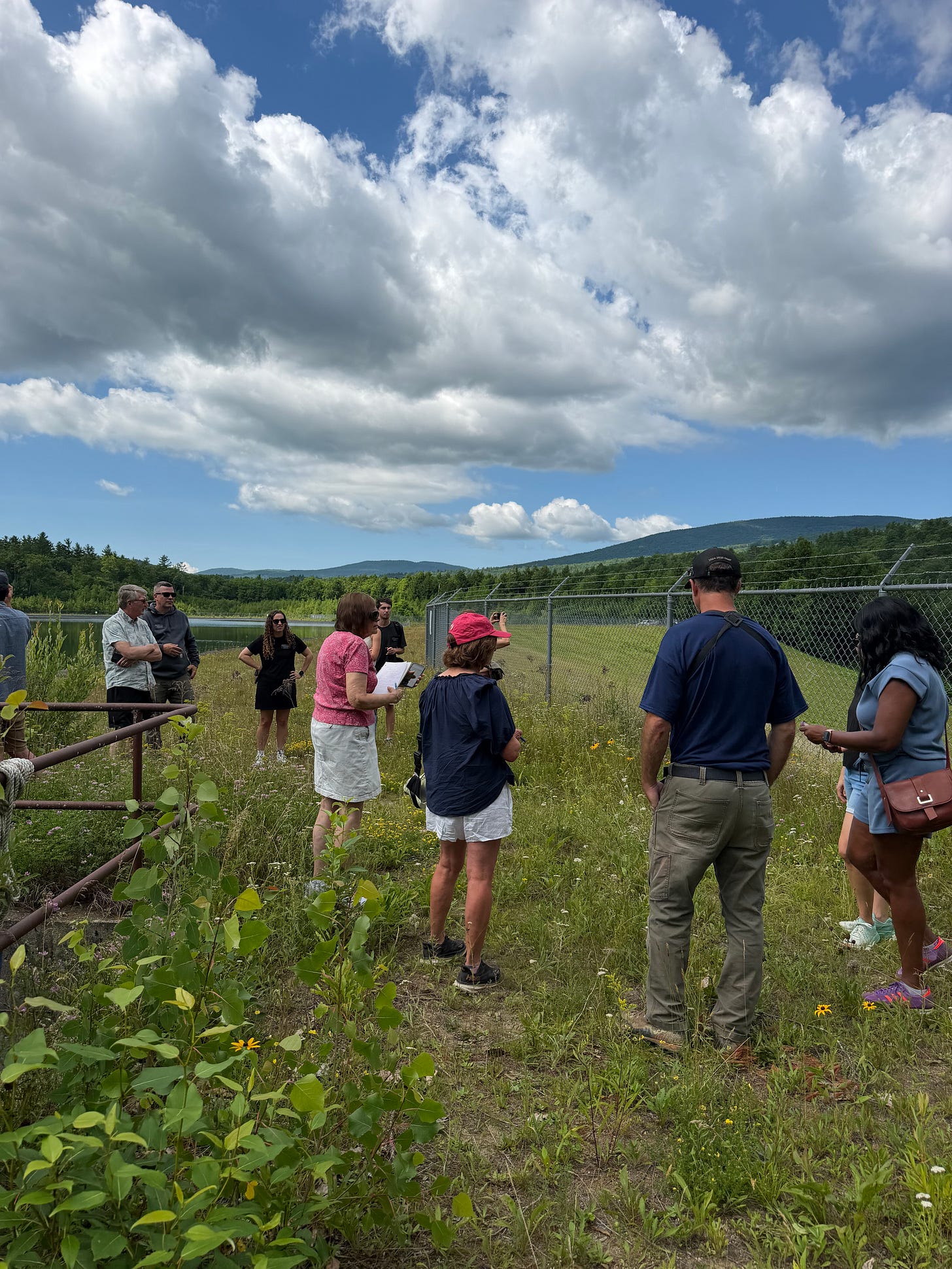 Journalists tour Okemo Mountain's snowmaking reservoir during a behind-the-scenes look at the resort's summer infrastructure upgrades.
