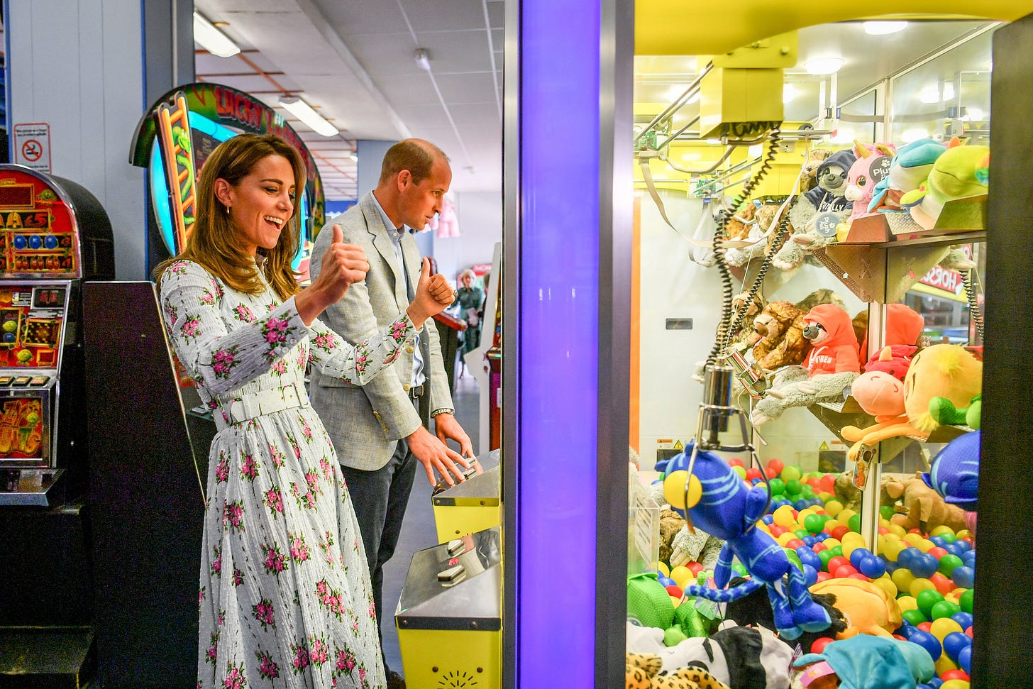 Princess Catherine and Prince William playing on a vending machine