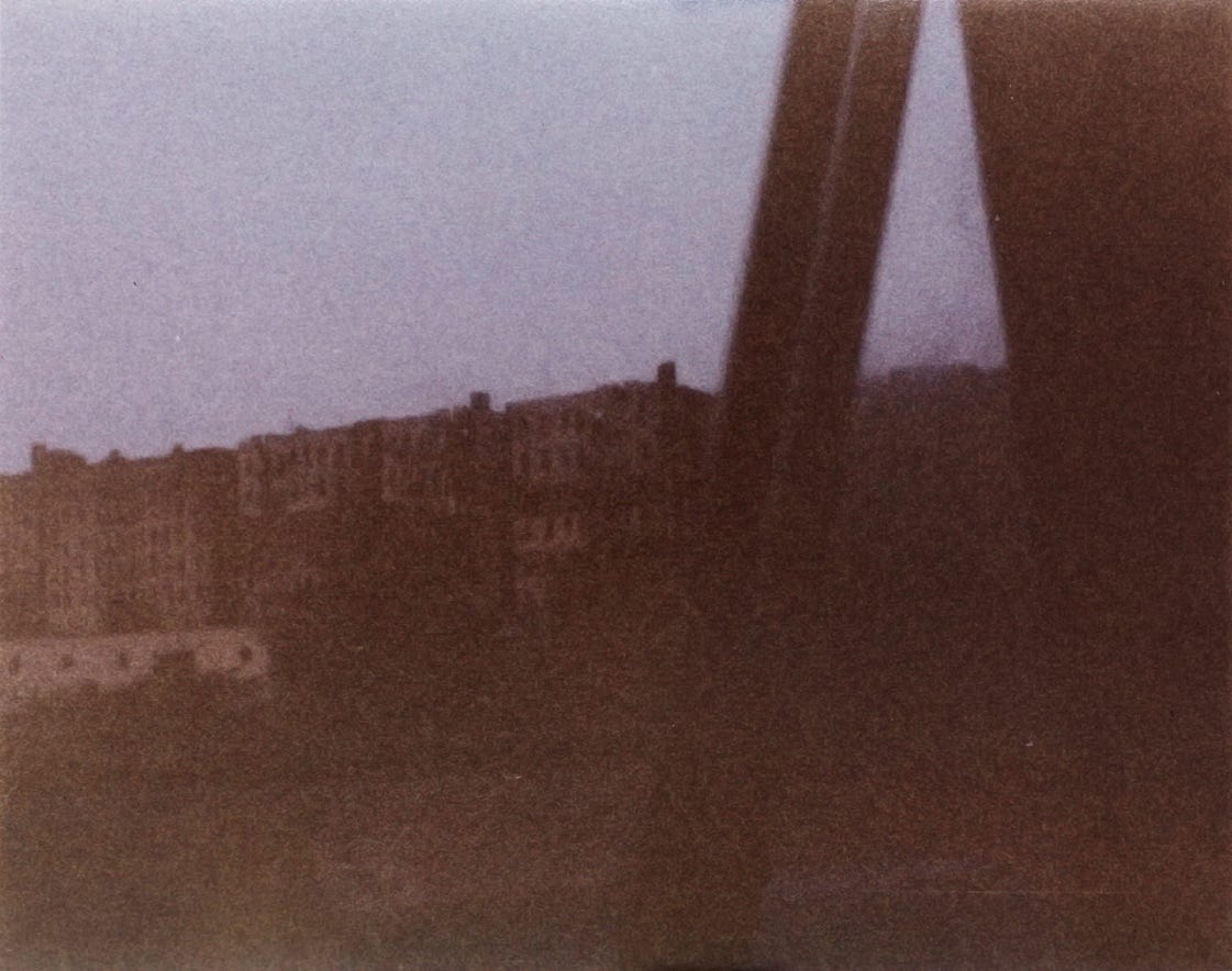 A blurry image of a building

Description automatically generated