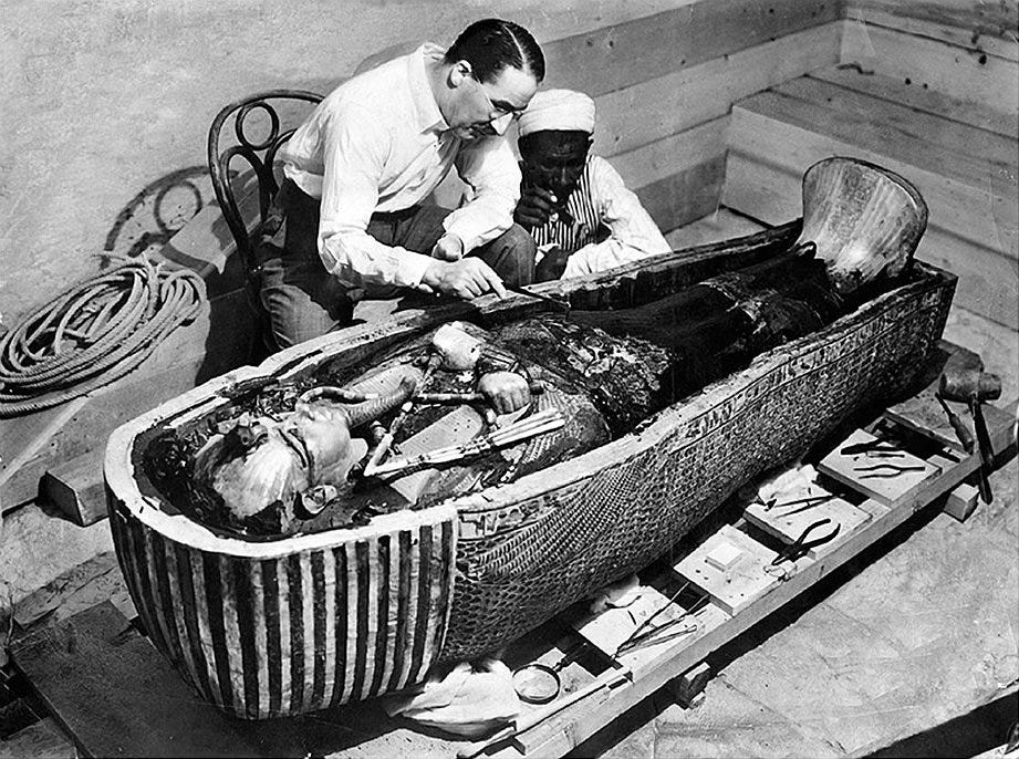 Howard Carter and an Egyptian foreman work on the innermost coffin of Tutankhamun during the excavation of the tomb.