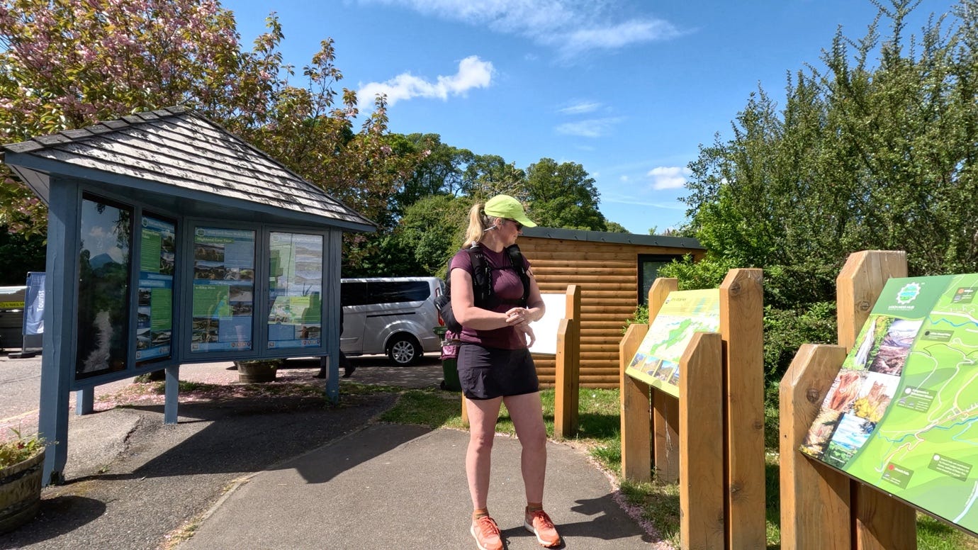 A person standing outside with a sign

AI-generated content may be incorrect.