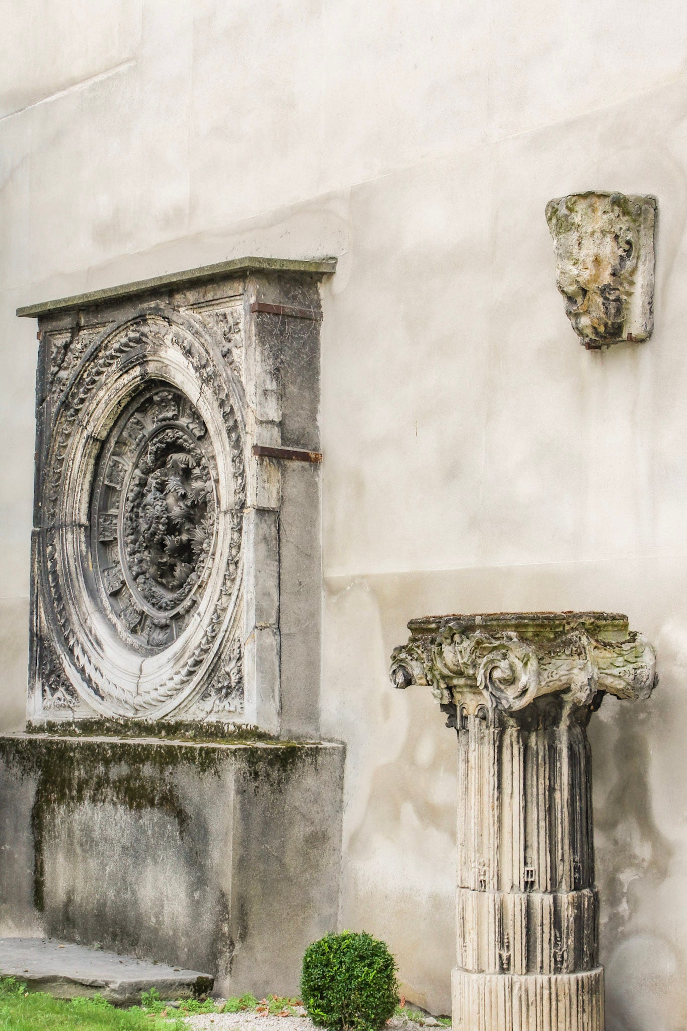 Historic architectural fragments displayed against a garden wall at Square Georges Cain in Paris.
