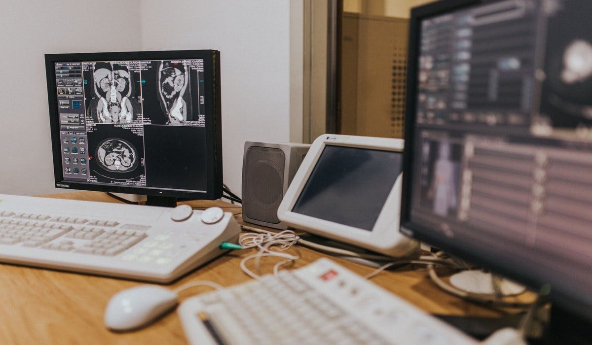 Radiologist reviewing AI-assisted diagnostic output Radiologist reviewing AI-assisted diagnostic output