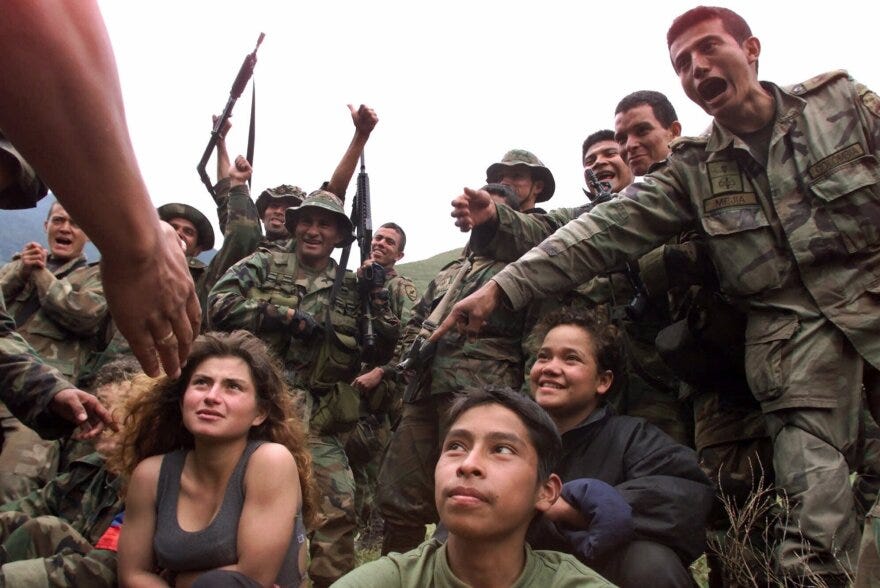 Kid Combatants: In this Dec. 21, 2000 photo, soldiers guard three captured teenage rebels of the Revolutionary Armed Forces of Colombia, FARC, in the mountains of Santander state in northwestern Colombia.