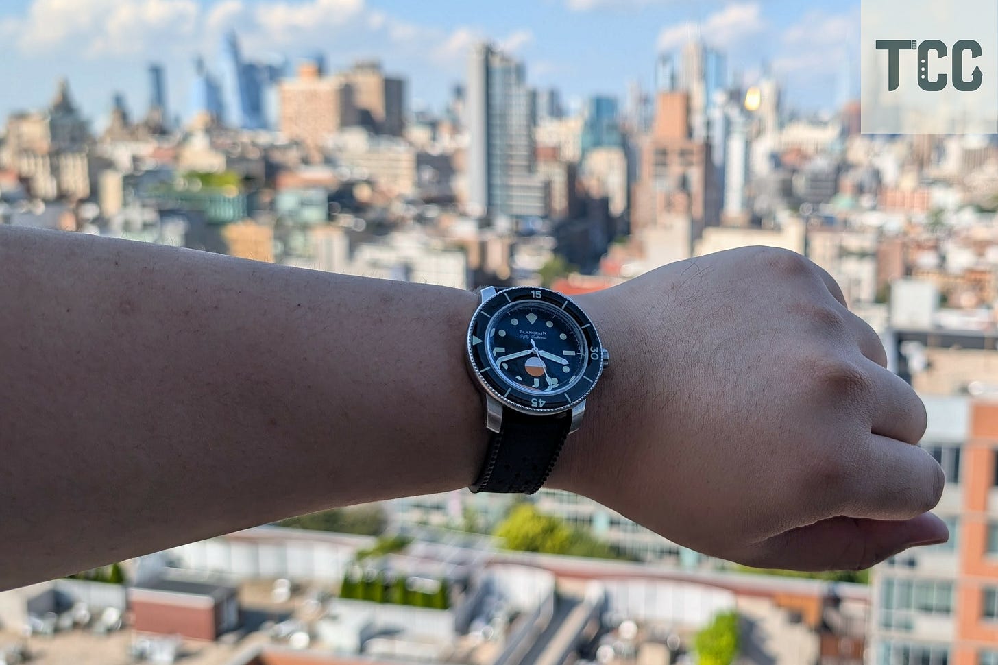 Wrist-shot of the Blancpain Fifty Fathoms MIL-SPEC against the Manhattan skyline.