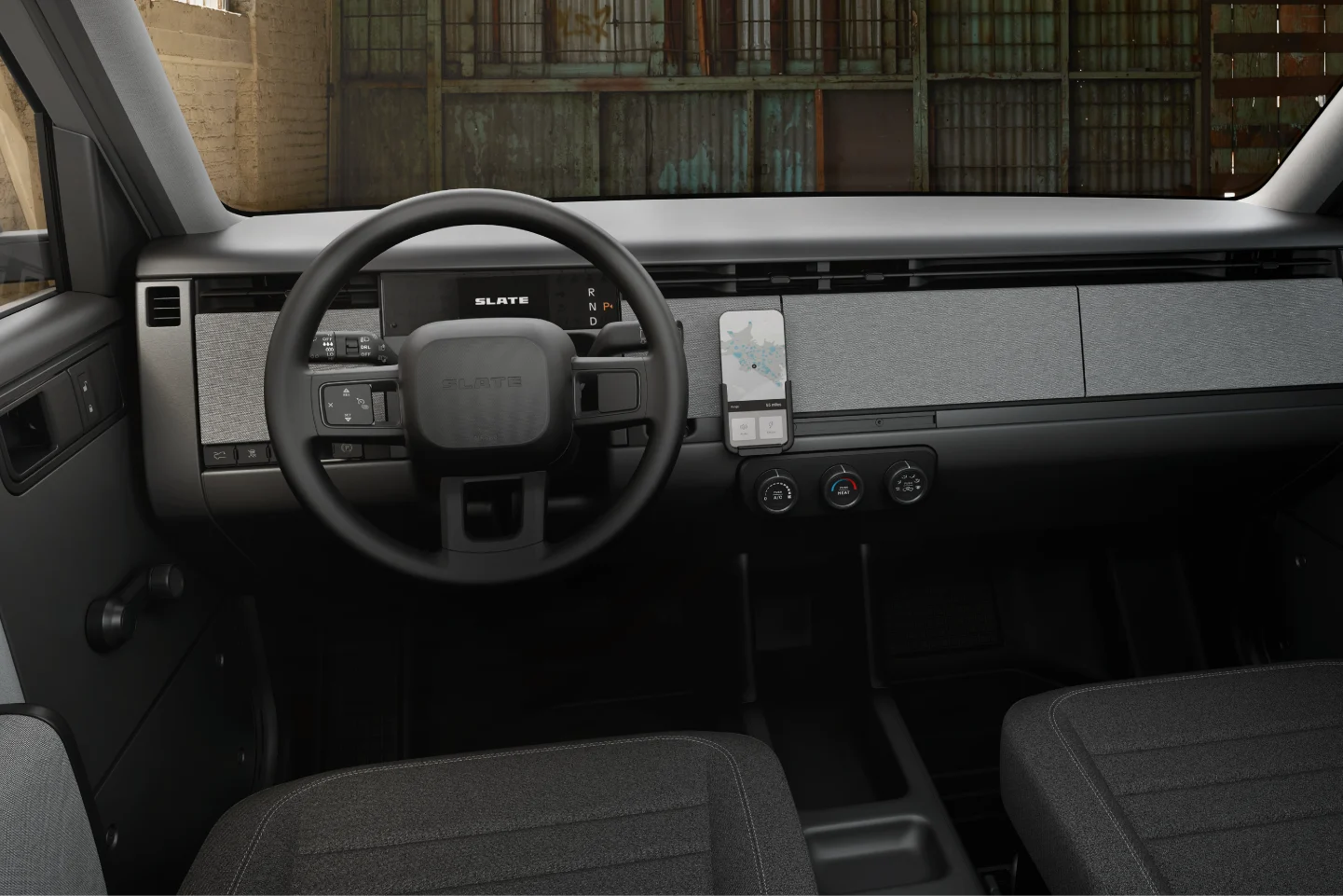 The interior of a vehicle including the steering wheel, from the drivers seat