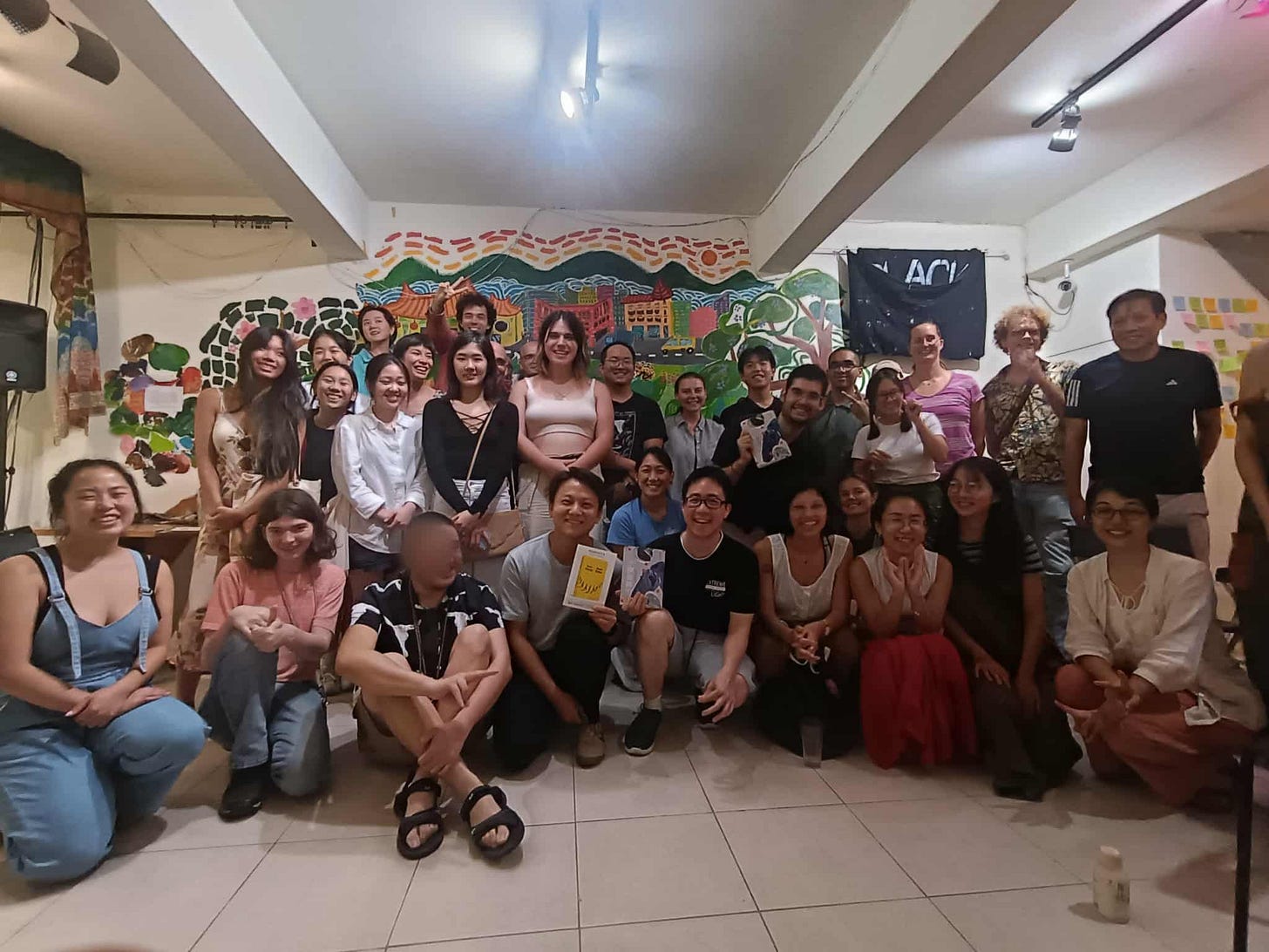 30-plus attendees smiling at the camera after a successful Stories of Taiwan evening.