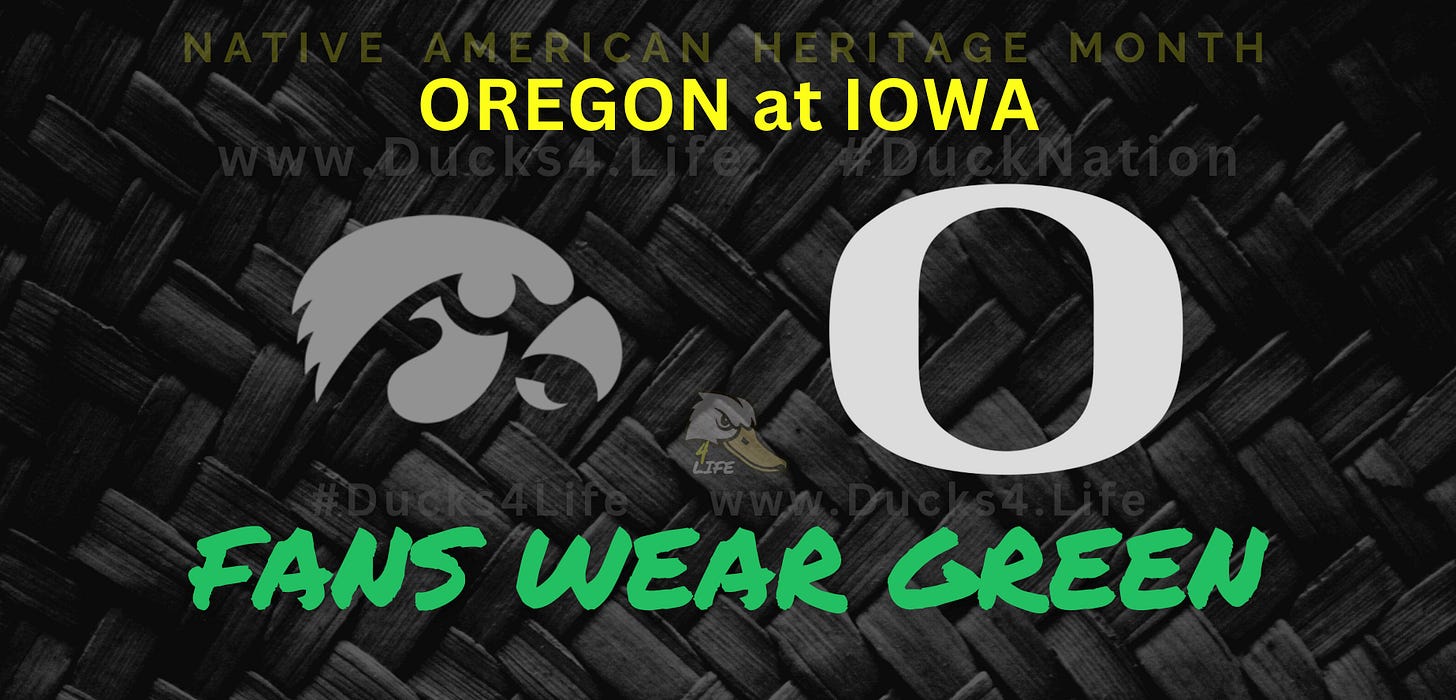 Graphic promoting Oregon vs. Iowa football game during Native American Heritage Month, featuring Oregon’s “O” logo opposite Iowa’s Hawkeye logo on a dark woven-texture background, with bold yellow text reading “OREGON at IOWA” and bright green script “FANS WEAR GREEN.” Deals on seats, fan gear, and premium Oregon Football coverage at www.Ducks4.Life