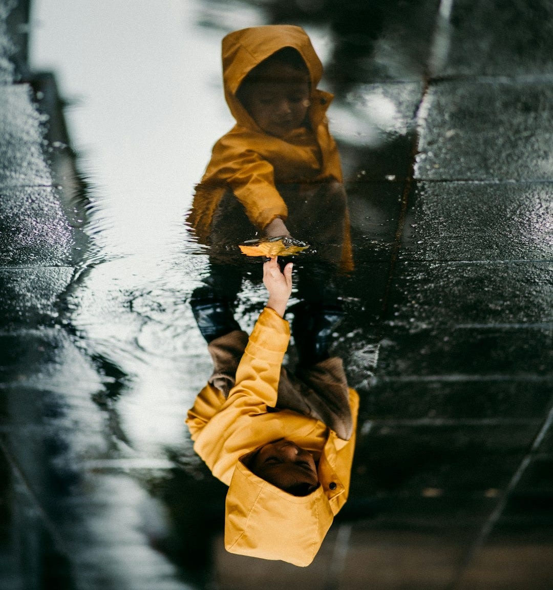 toddler in yellow raincoat