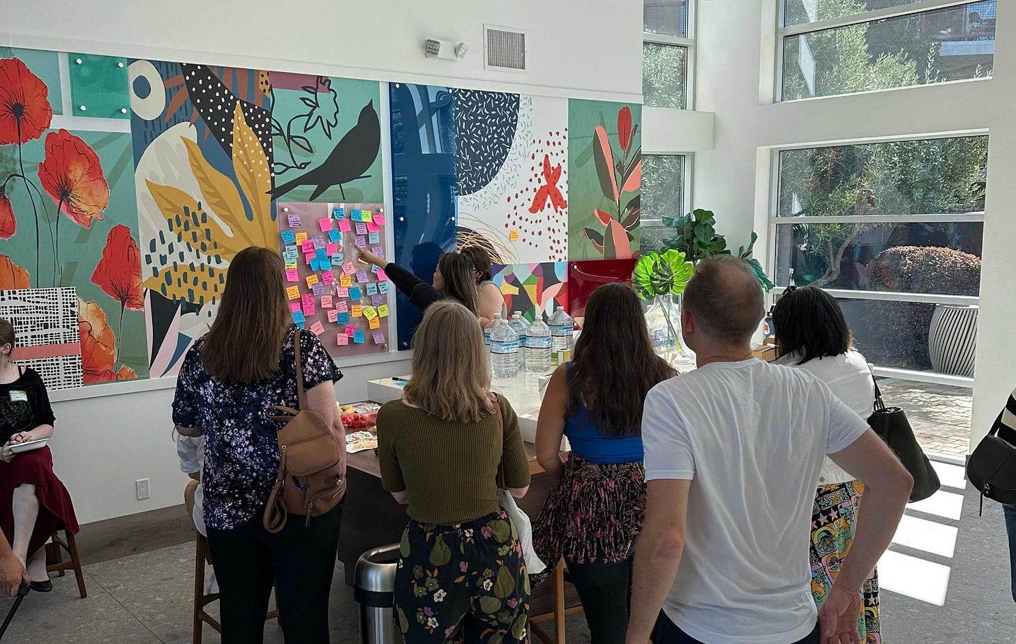 A group of people talking about post it notes in order to plan the day