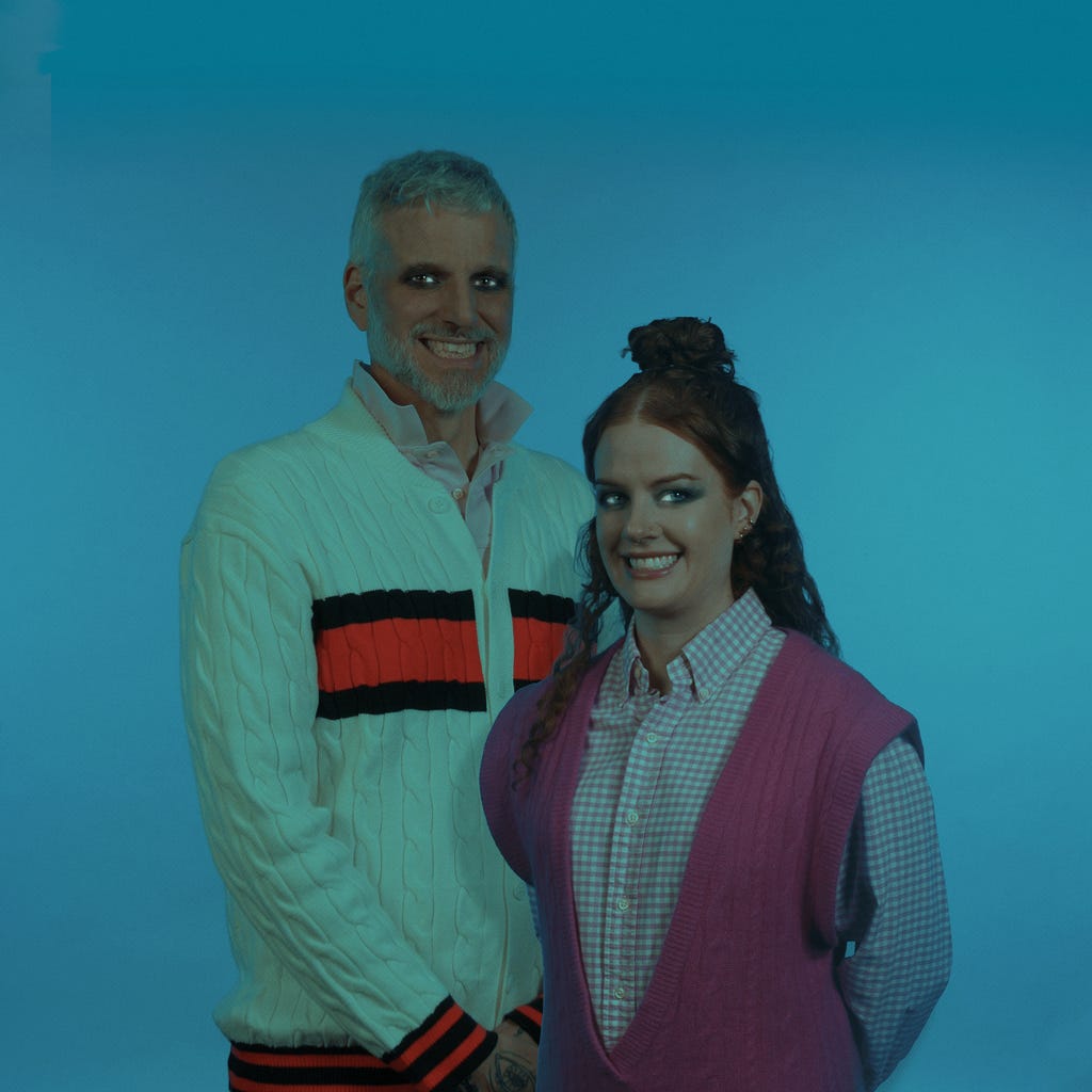 Publicity photo of Dream Eaters used for their Tarot DMs feature, showing the duo smiling together against a blue studio backdrop. Publicity photo of Dream Eaters used for their Tarot DMs feature, showing the duo smiling together against a blue studio backdrop.