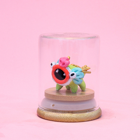 6 images of baby dragon sculptures each in a small glass jar