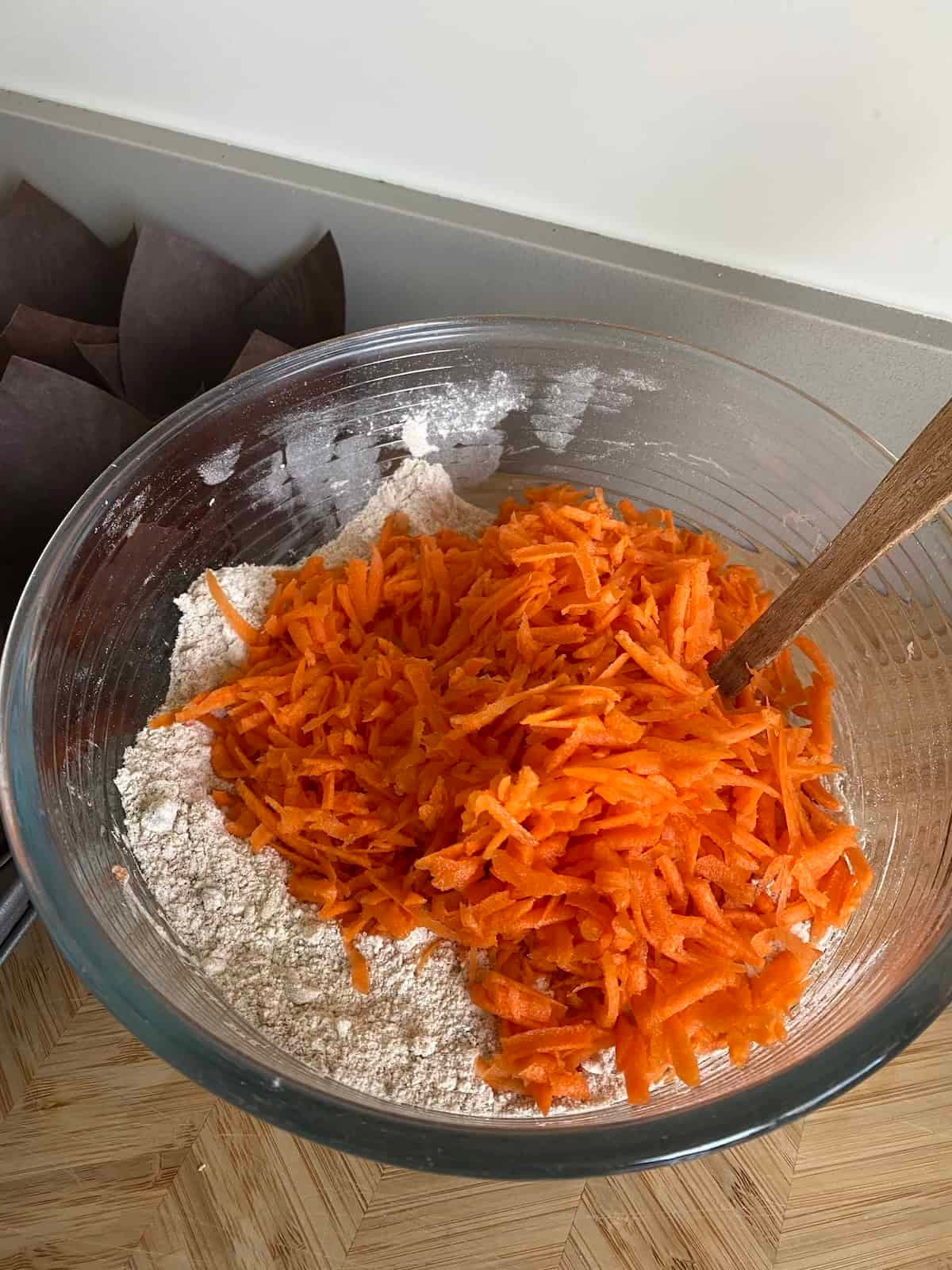 Add grated carrots to the dry ingredients. Add grated carrots to the dry ingredients.