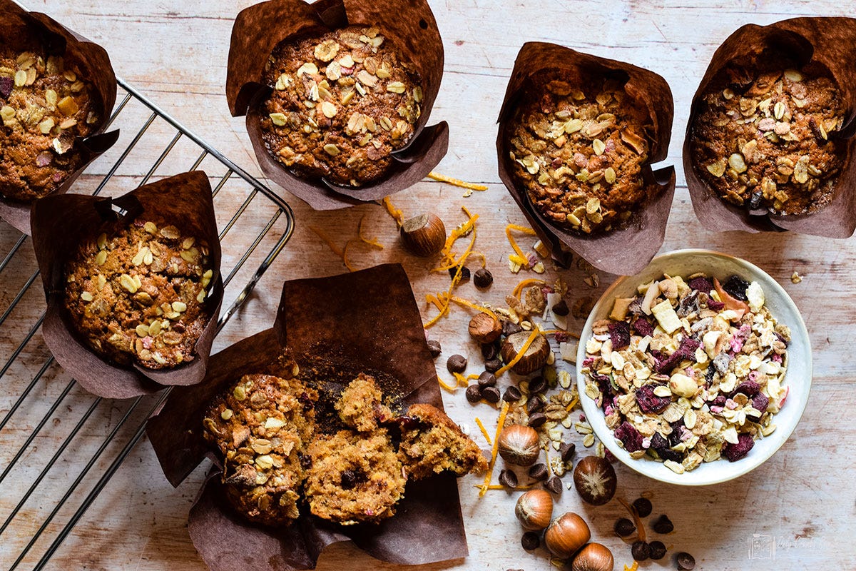 breakfast muffins in paper cases with one removed and broken open.