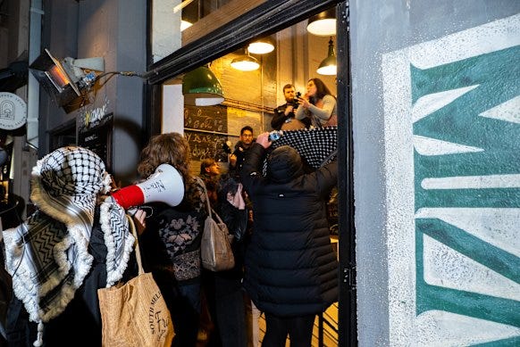 A group storms Miznon restaurant in Hardware Lane on Friday night.