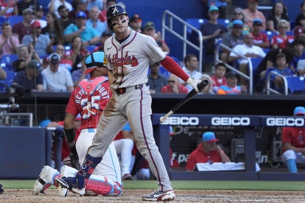 Jarred Kelenic heads to the dugout after striking out against the Marlins