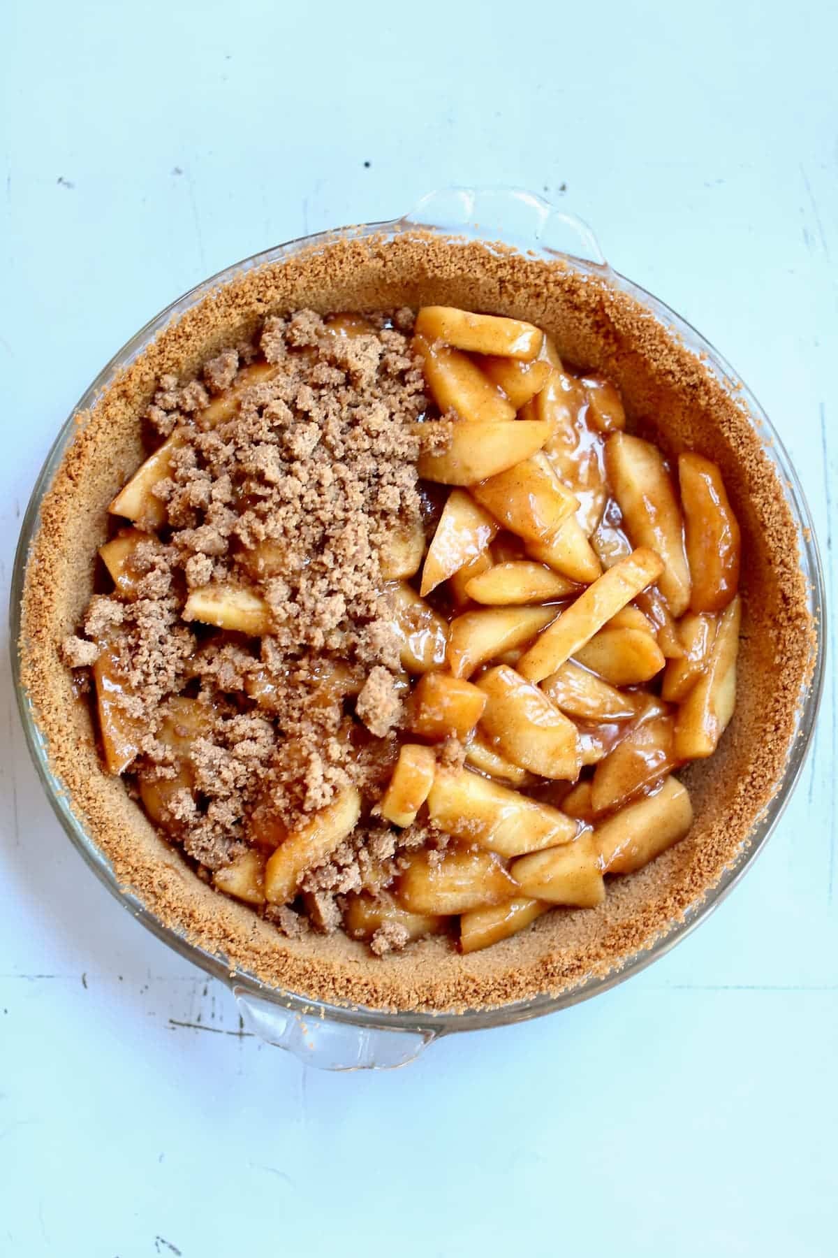 a half-finished pie on a blue table.