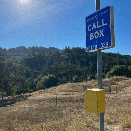 Rainbow Squared, Year 5, Piece Thirty-Six: 31. Blue Yellow. An animated photo loop of  California highway emergency call boxes, with a blue sign that says “CALL BOX” including specific coordinated sits on a pole atop a yellow box. We see several shots of cards passing by these signs and then a close up of a hand opening the box and looking inside to reveal the phone and a QWERTY keypad.