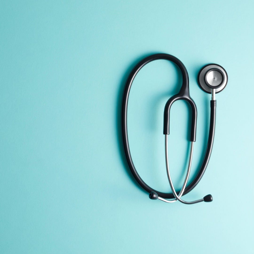 A photo of a black stethoscope on the right-hand side against a light blue background.