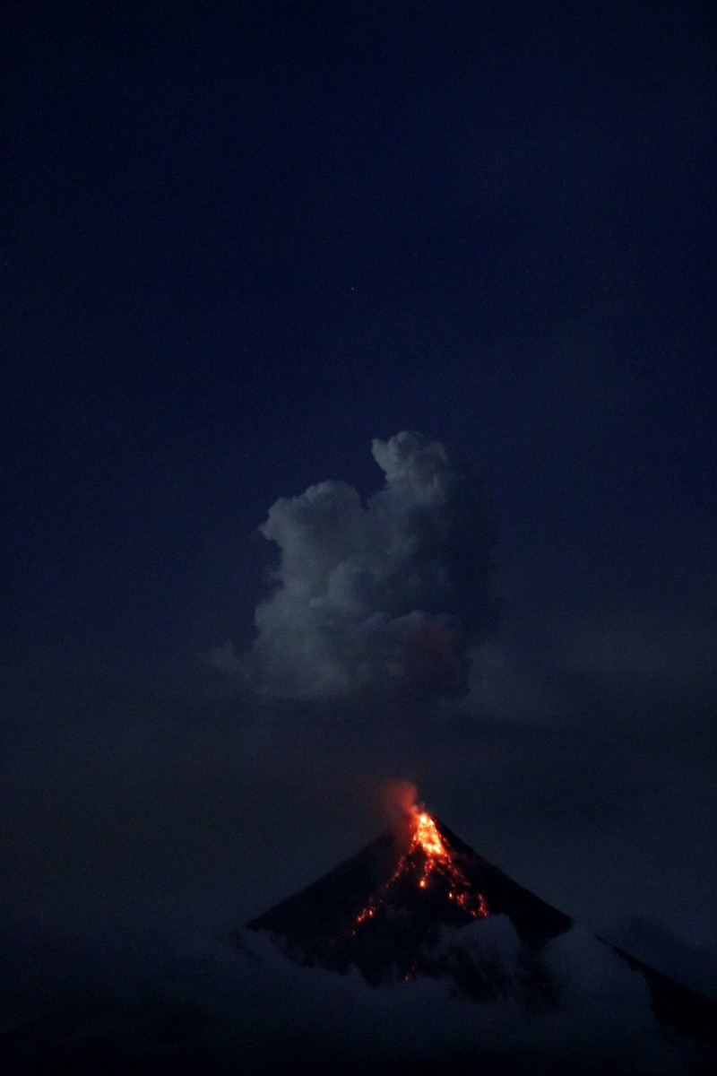 Flame from volcano peak at night Flame from volcano peak at night
