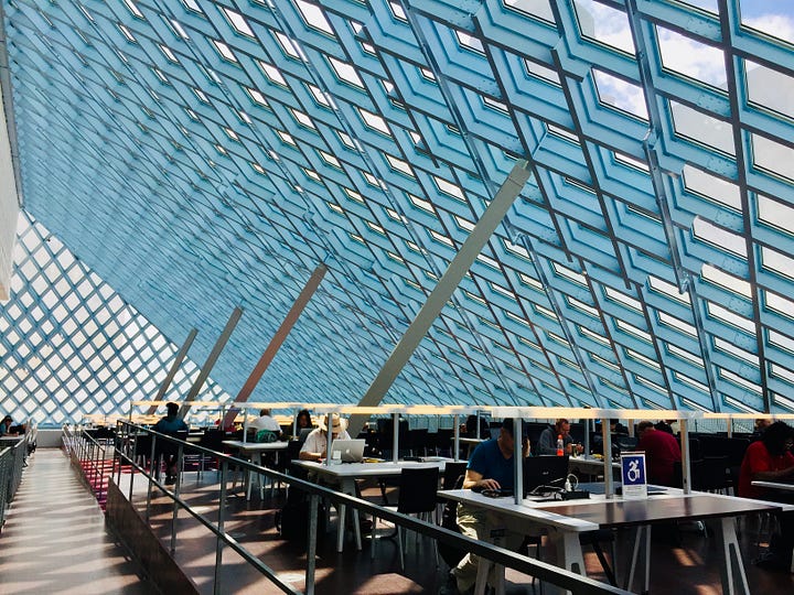 Four photos of libraries, featuring shelves of books and patrons