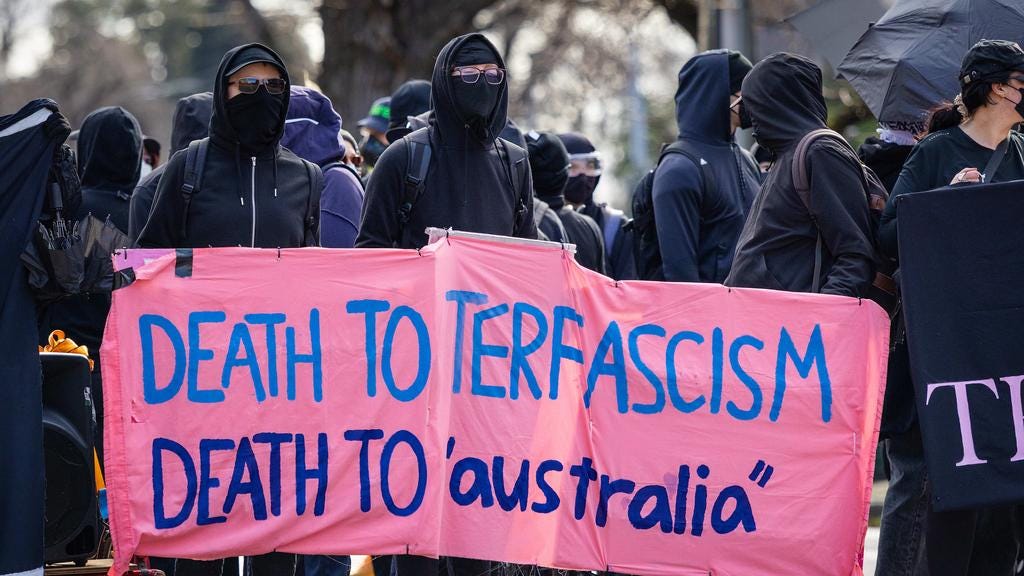 Trans rights activists, who covered their faces, protest in Melbourne. Picture: Mark Stewart