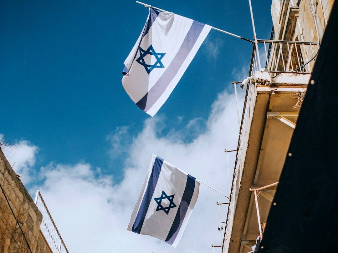 flags hanging on roof during daytime