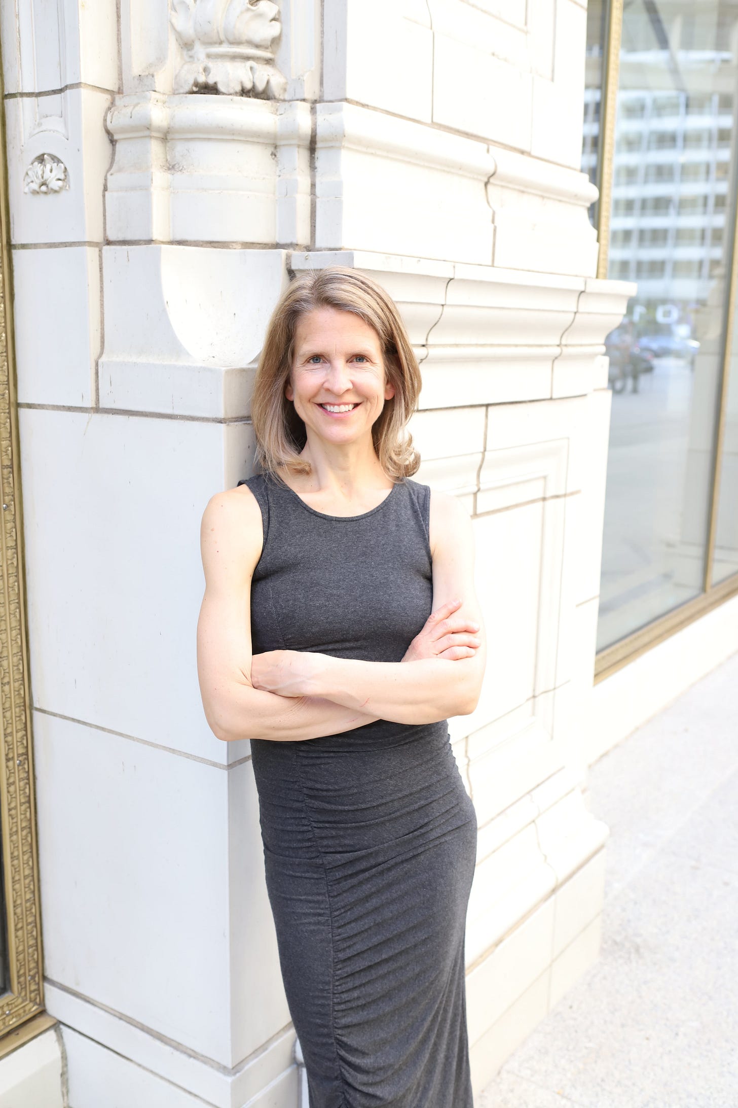 Photo of Sarah Fay, standing, ready to help