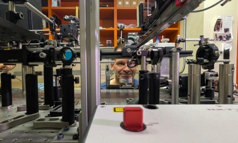 Man looking into laser machinery system