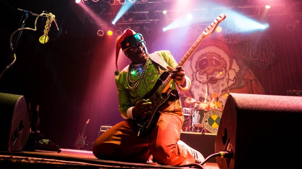 A man sitting on a stage with a guitar. Guitar solo live music, music. -  PICRYL - Public Domain Media Search Engine Public Domain Search