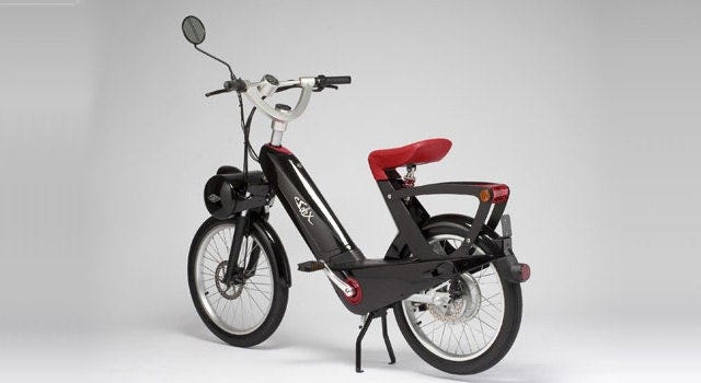 This image may contain Vehicle Transportation Vespa Motor Scooter Moped and Motorcycle
