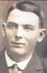 An old sepia photograph of a young man in a suit and tie.