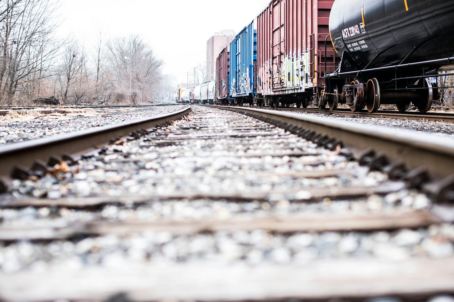 photo of a train rails beside container van