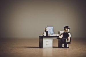 Depressed businessman in a Little People doll format