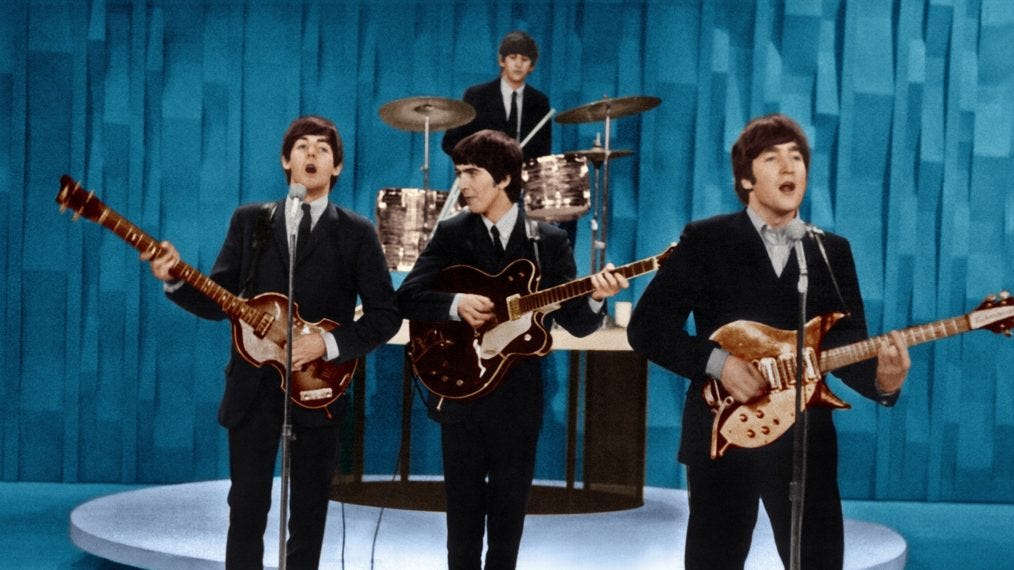The four members of The Beatles centered around a drum kit during the band's appearance on The Ed Sullivan Show on February 9, 1964.