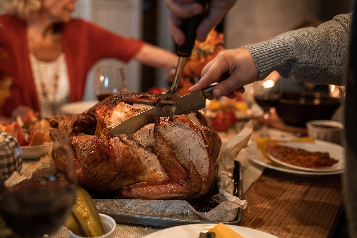 person slicing meat on table person slicing meat on table