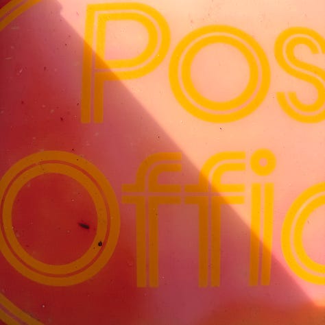 Photographs show a range of red subjects - a notebook cover top left, a close up of a plastic red toy, a faded red post office sign, a red letter box, a red and white rope on a dog toy and a red sign offering home made coffe